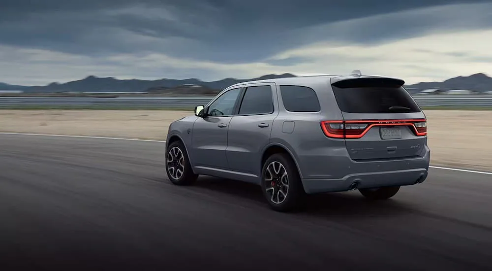 Rear view of a silver 2024 Dodge Durango Hellcat on the highway.