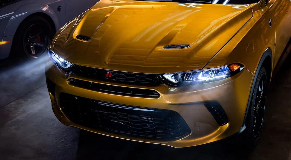 The front end of a yellow 2024 Dodge Hornet GT at a Dodge dealer.